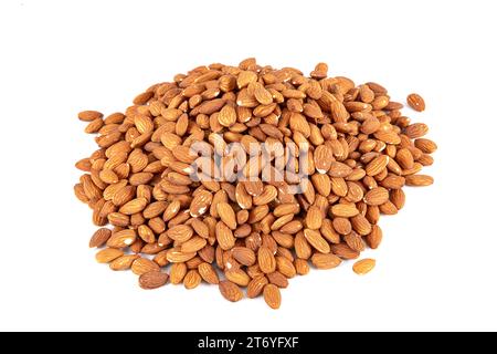 Close-up view of raw almonds without shells from above. Close-up raw brown almond seeds in copper bowl isolated on white background. Top view. It was Stock Photo
