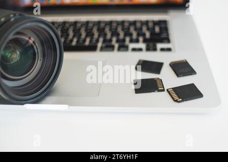 Close up camera lens memory cards laptop Stock Photo