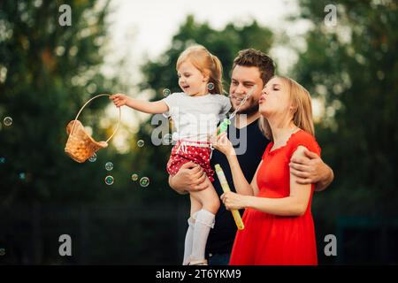Fun family time while blowing soap bubbles Stock Photo