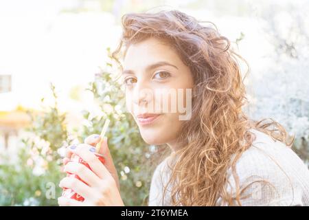 Modern woman drinking coke Stock Photo