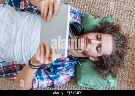 Modern man using tablet home Stock Photo