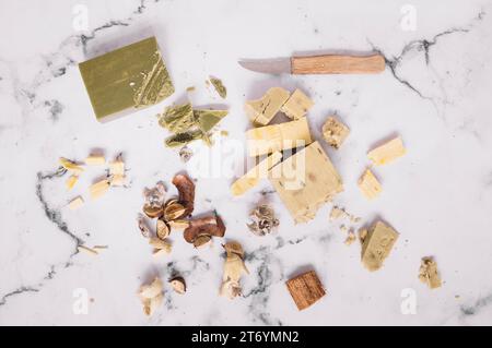 Pieces soap bars knife marble backdrop Stock Photo