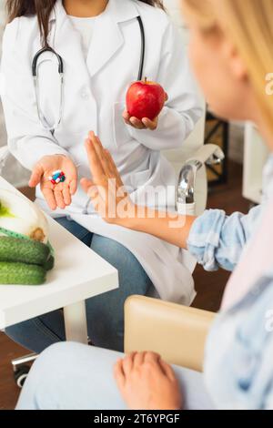 Close up doctor comparing fruits pills Stock Photo