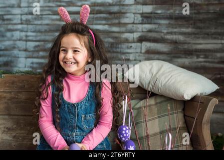 Happy girl bunny ears with easter eggs Stock Photo
