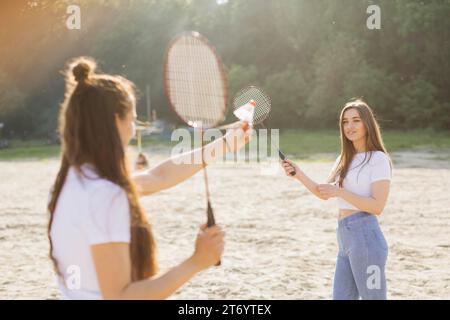 Medium shot happy girls playing badminton Stock Photo