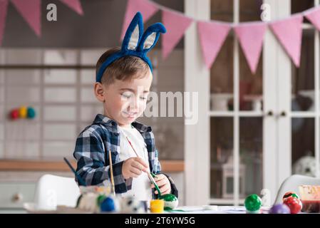 Portrait cute little boy painting eggs easter Stock Photo