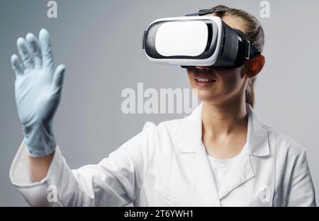 Smiley female researcher using virtual reality headset Stock Photo