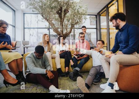 Multicultural colleagues collaborate on innovative projects and boost corporate growth in a dynamic and productive co-working space. Stock Photo