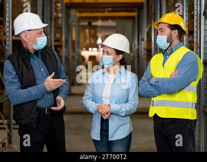 Employees with masks working warehouse 3 Stock Photo