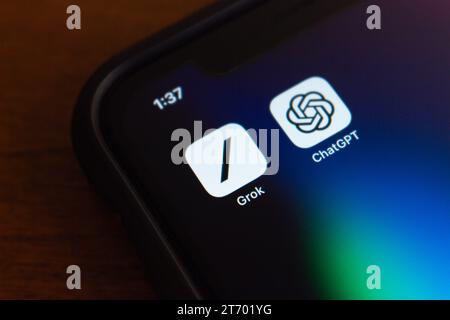 Vancouver, CANADA - Nov 8 2023 : Grok, an AI chatbot by xAI, with ChatGPT icons seen in iPhone screen. Generative AI and modern chatbot tech concept Stock Photo