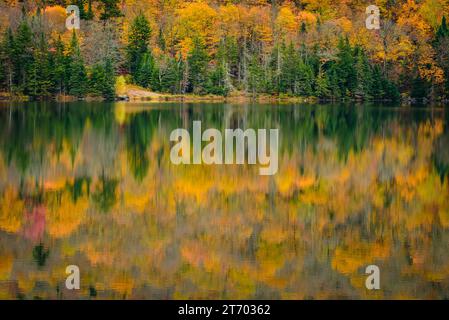 Fall colors reflecting on a pond Stock Photo