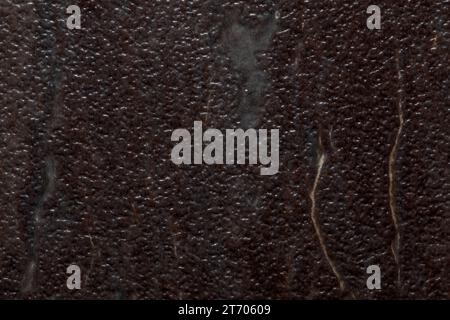 Textured background image resembling divoted or dimbled brown stone with marbling streaks. Stock Photo