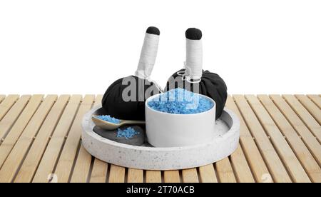 Bowl with blue salt and herbal bags on wooden table near sea Stock ...