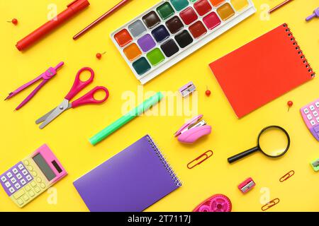 Composition with different school supplies on yellow background Stock Photo