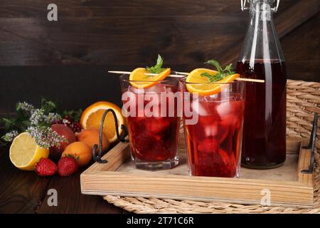 Delicious refreshing sangria, fresh fruits and berries on wooden table Stock Photo