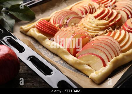 Baking tray with uncooked apple galette on wooden table, closeup Stock Photo