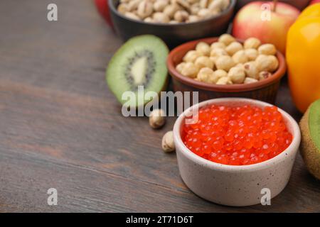 Many different products on wooden table, closeup and space for text. Natural sources of serotonin Stock Photo