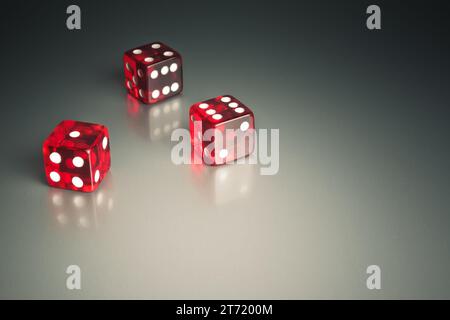 three red dice in the corner on a silver gaming table; three red dice in the corner on a silver gaming table Stock Photo