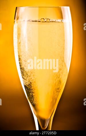 close up of champagne flute on golden background Stock Photo