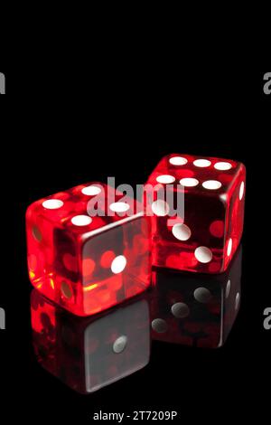 detail of red dice on transparent black background Stock Photo