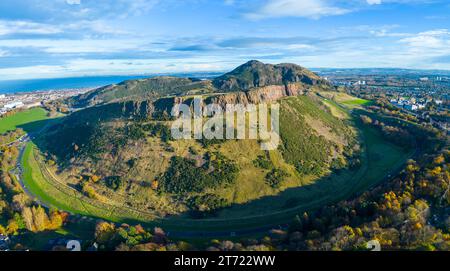 Aerial view of Salisbury Crags with Arthur’s Seat to rear in autumn  in Holyrood Park, Edinburgh, Scotland, UK Stock Photo