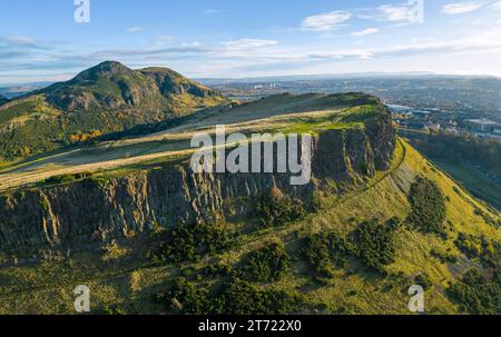 Aerial view of Salisbury Crags with Arthur’s Seat to rear in autumn  in Holyrood Park, Edinburgh, Scotland, UK Stock Photo