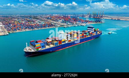 Aerial view of cargo ship carrying container running for export import near cargo yard port concept freight shipping. Stock Photo