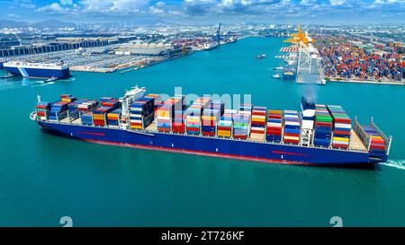 Aerial view of cargo ship carrying container running for export import near cargo yard port concept freight shipping. Stock Photo