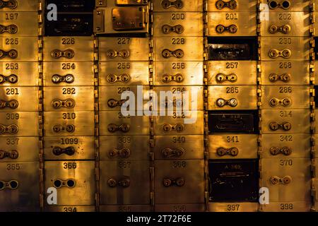 The historic vault of the Central Standard Building in Chicago, Illinois, United States, shows rows of numbered brass safe-deposit boxes, once the largest in the city. A few boxes, such as numbers 257 and A518, show darker fronts with differing locks. The building, completed in 1924 on LaSalle Street, opens the vault to the public during the Open House Chicago festival. Stock Photo