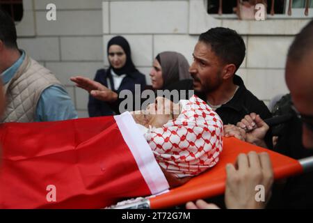 Mourners carry the body of Issa al-Qadi, a 66-year-old Palestinian man ...