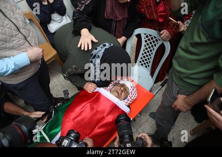 Mourners carry the body of Issa al-Qadi, a 66-year-old Palestinian man ...