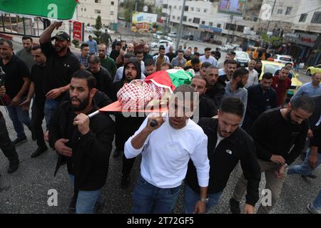 Mourners carry the body of Issa al-Qadi, a 66-year-old Palestinian man ...