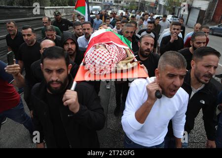 Mourners carry the body of Issa al-Qadi, a 66-year-old Palestinian man ...