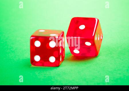 two red dices on green background Stock Photo