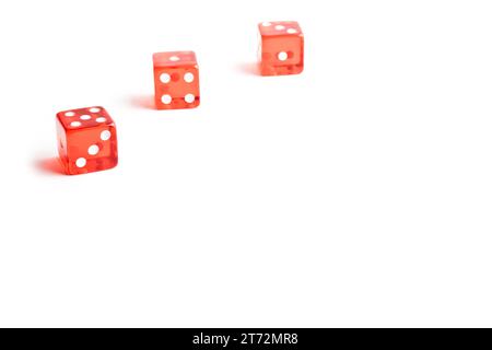 three red dice in a corner on white background with space for the text Stock Photo