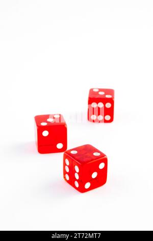 detail of three red dice on white background Stock Photo