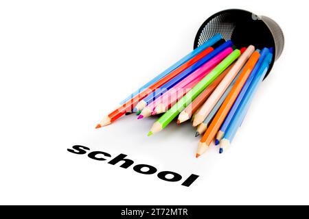 detail of  stack of colour pencils near the word school on white background Stock Photo