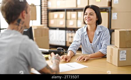 Two ecommerce business worker and client speaking at office Stock Photo