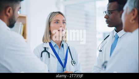 Group, professional woman and doctors meeting, planning or cooperation on medical help, clinic service or healthcare. Discussion, leader and team Stock Photo