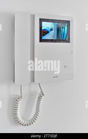 Video intercom with talkback or doorphone voice communications system mounted on wall, close up view Stock Photo