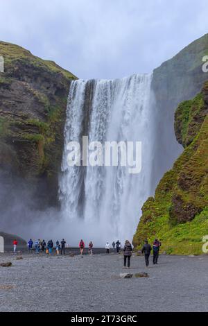 Skogar Iceland - July 28, 2023: Tourists visiting Skogafoss waterfall in south Iceland Stock Photo