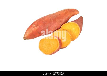 Sweet potato or sweetpotato whole and sliced tubes with red skin and yellow flesh isolated on white. Vegetable food staple. Stock Photo