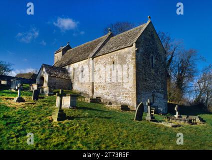 View NW of St Michael's Church built on a steep hillside overlooking the valley of the Dunt stream, Duntisbourne Rouse, Gloucestershire, England, UK. Stock Photo