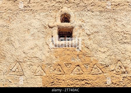 Wall made of clay with a small window and a national Muslim ornament Stock Photo