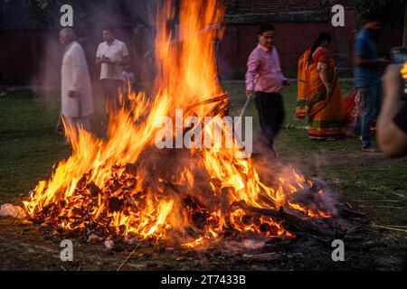 people dancing around a huge bon fire on the hindu festival of holi lohri celebrating the festival of colours and a good harvest and the end of winter Stock Photo