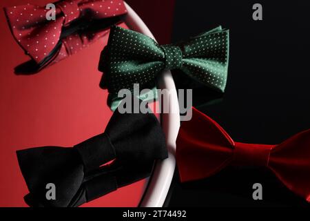Different stylish bow ties on color background Stock Photo