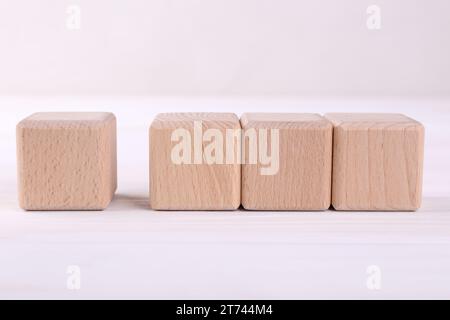 International Organization for Standardization. Wooden cubes with check mark and abbreviation ISO on white table Stock Photo