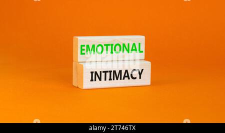 Emotional intimacy symbol. Concept words Emotional intimacy on beautiful wooden blocks. Beautiful orange table orange background. Psychology emotional Stock Photo