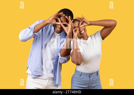 Black couple making fun glasses with fingers Stock Photo
