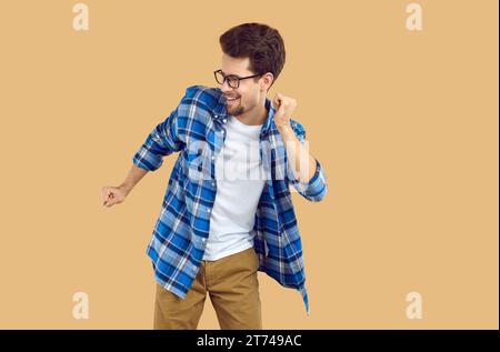 Happy young man dancing over isolated studio background Stock Photo